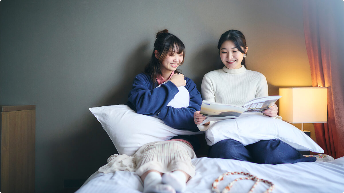 Guest relaxing on a room bed